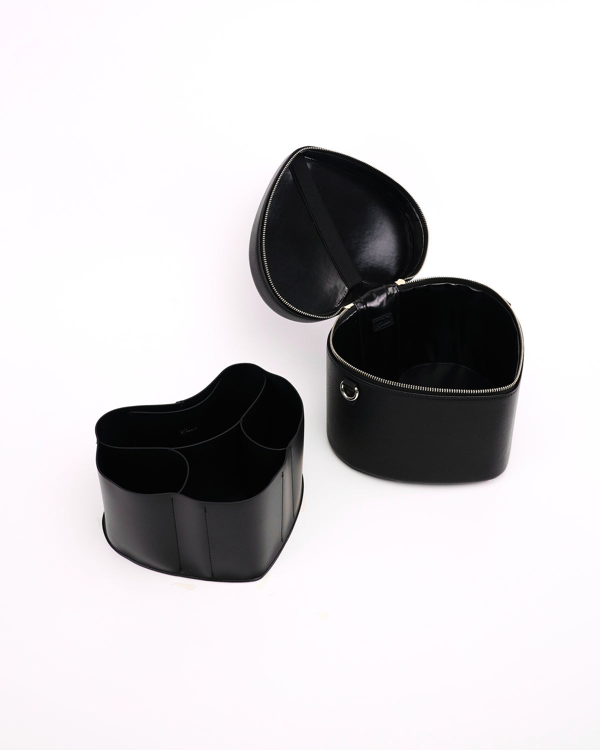 Open GALS Mini Lovette Vanity Case in Onyx with its removable organiser placed beside the case